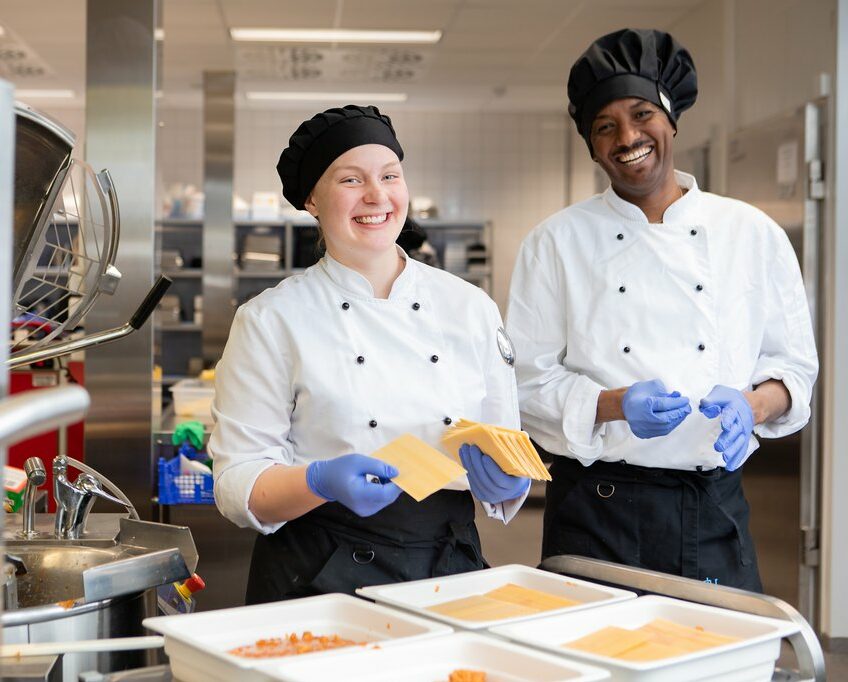 Two Tredu students smiling at camera