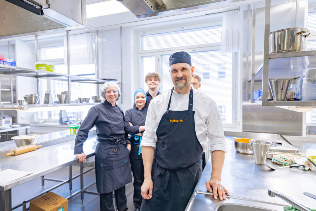 Ravintola- ja cateringalan opettaja ja opiskelijoita.